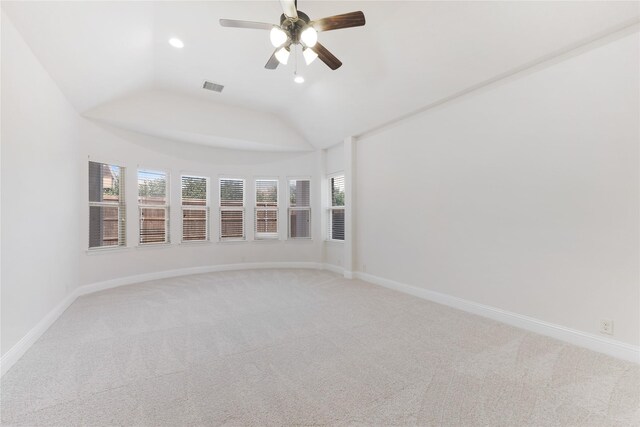 spare room featuring light colored carpet, visible vents, and baseboards