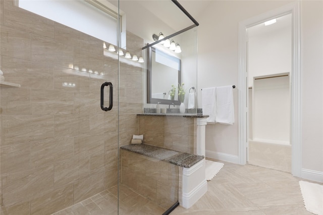 full bathroom featuring baseboards and a stall shower