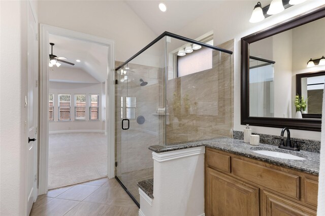 empty room featuring baseboards, built in features, lofted ceiling, light carpet, and a ceiling fan