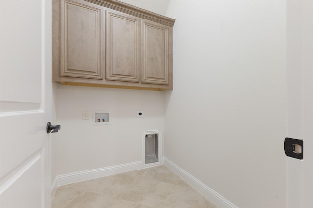 washroom with electric dryer hookup, baseboards, cabinet space, and washer hookup