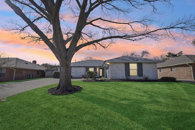 view of front of house with driveway, a front lawn, and brick siding