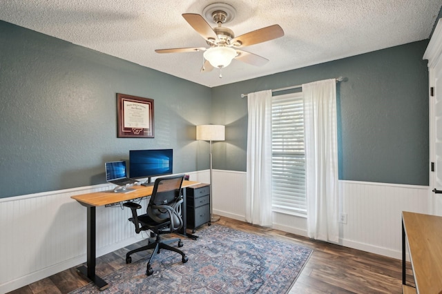 office with a wainscoted wall, a textured ceiling, and wood finished floors