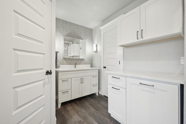 interior space featuring vanity and wood finish floors