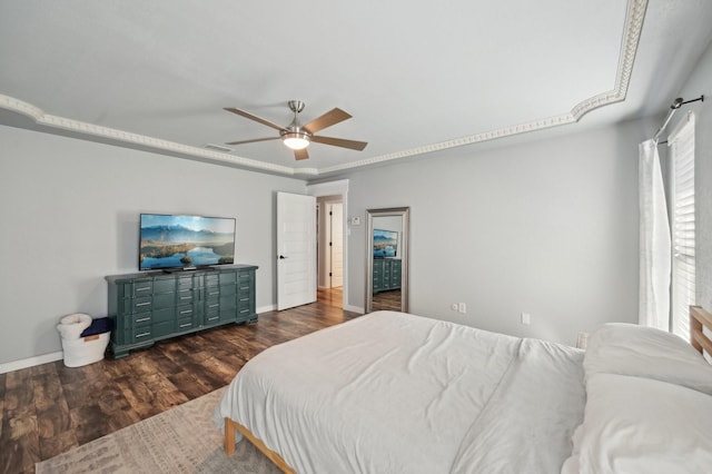 bedroom featuring a ceiling fan, visible vents, baseboards, and wood finished floors