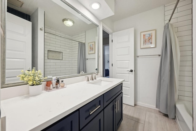 full bathroom featuring vanity and baseboards