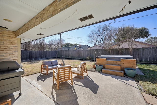 view of patio with a fenced backyard, a hot tub, grilling area, and an outdoor hangout area