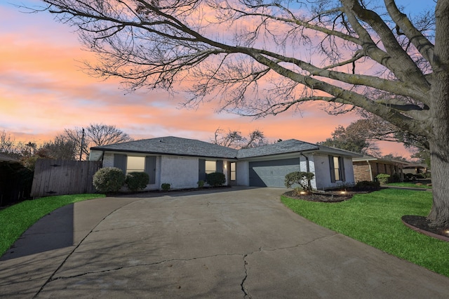 view of front of house with a garage, brick siding, fence, concrete driveway, and a front lawn