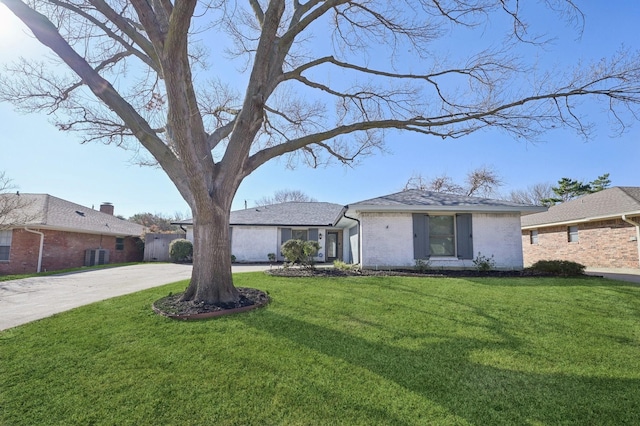 ranch-style home featuring driveway, brick siding, a front lawn, and central AC unit