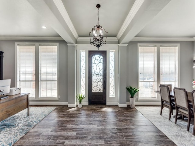 entryway with baseboards, dark wood-type flooring, a wealth of natural light, and an inviting chandelier