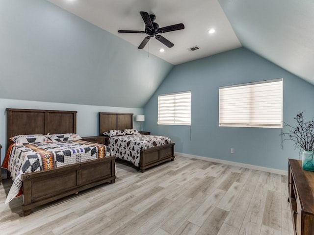 bedroom with light wood-style flooring, visible vents, vaulted ceiling, and baseboards