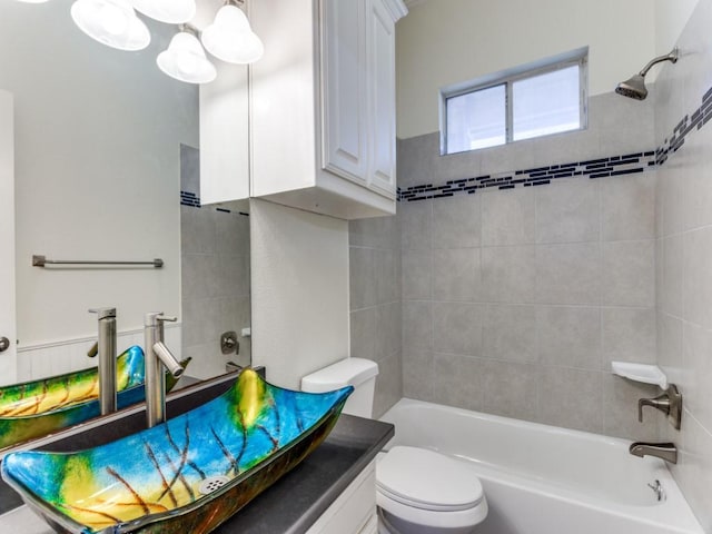 bathroom featuring bathing tub / shower combination, toilet, and vanity