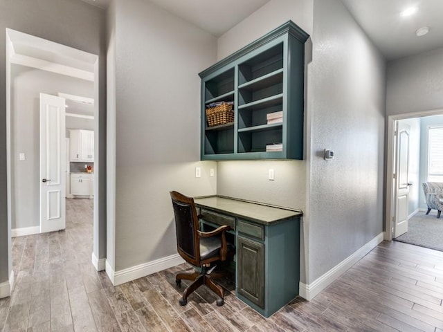 home office featuring baseboards and wood finished floors