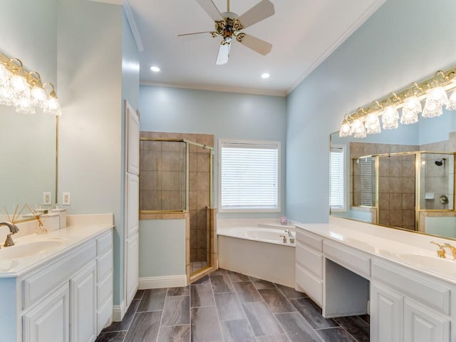 bathroom with crown molding, a stall shower, a garden tub, and a sink