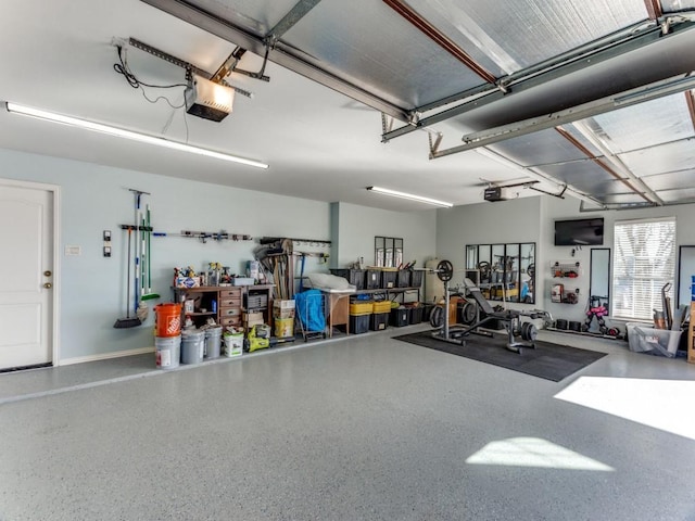 garage with baseboards and a garage door opener