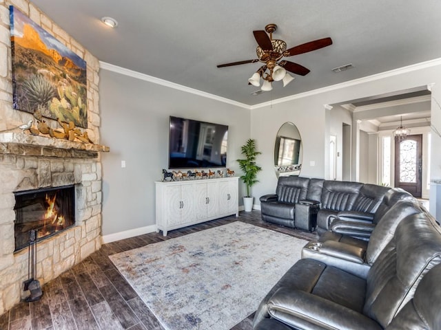 living area featuring a fireplace, wood finished floors, visible vents, baseboards, and crown molding