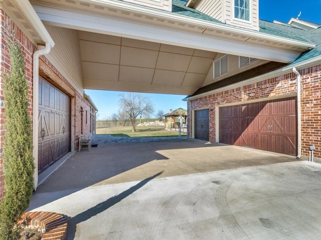 garage featuring concrete driveway