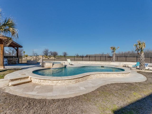 view of swimming pool featuring an in ground hot tub, a patio, a fenced backyard, and a fenced in pool