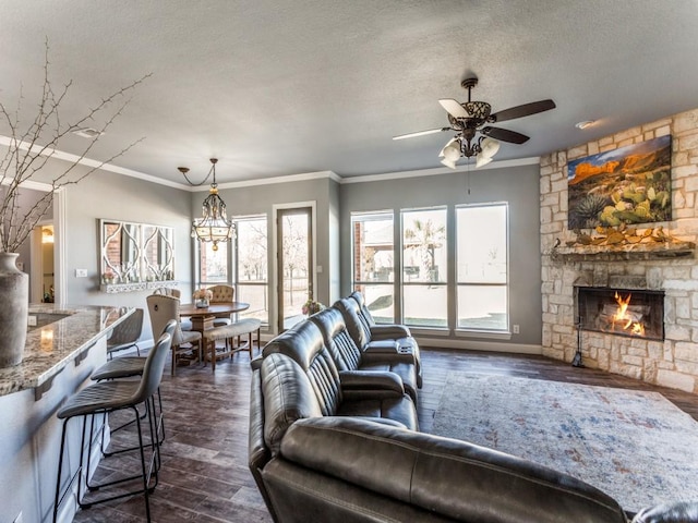 living area with a textured ceiling, plenty of natural light, a fireplace, and dark wood-style flooring