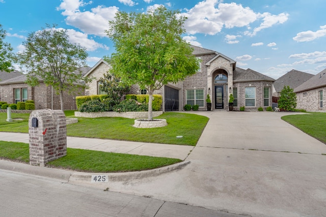 425 Brook Meadow Dr, Midlothian, TX 76065 - view of front of home with brick siding, a front lawn, and driveway