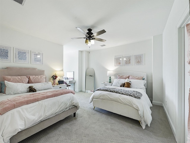 bedroom with a ceiling fan, light colored carpet, visible vents, and baseboards