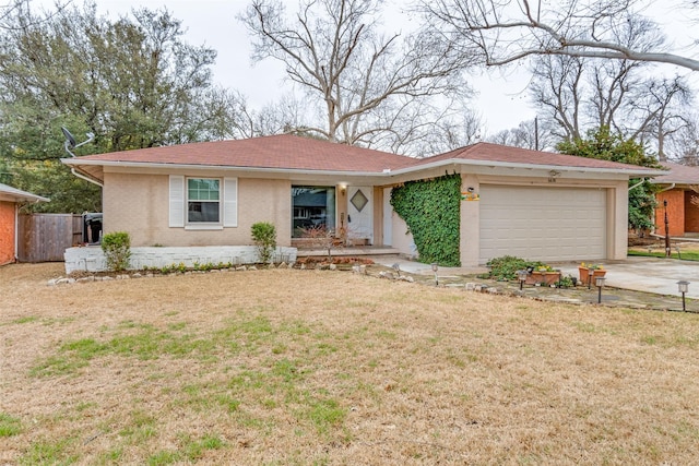 ranch-style home with brick siding, an attached garage, a front yard, fence, and driveway