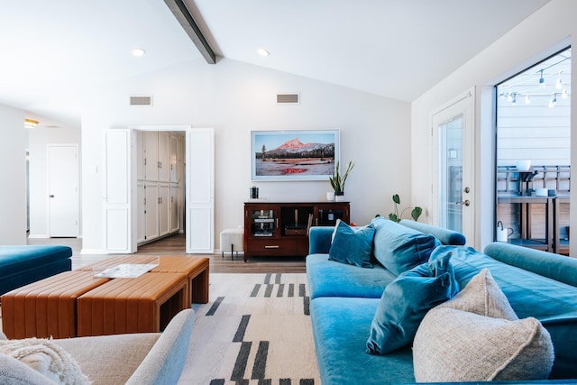 living room with light wood-style floors, french doors, visible vents, and vaulted ceiling with beams