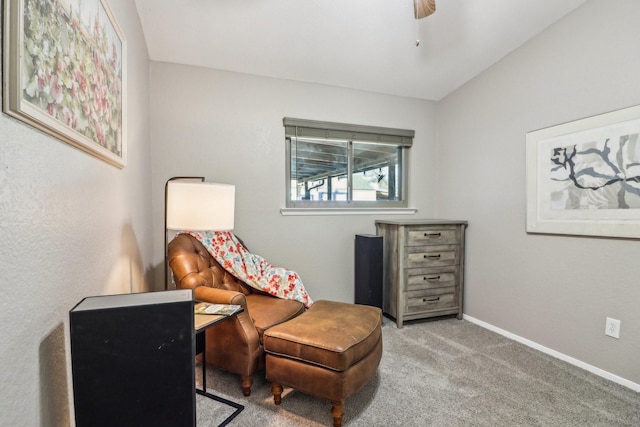 living area featuring a ceiling fan, lofted ceiling, carpet flooring, and baseboards