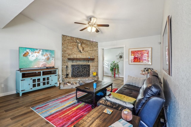 living room featuring a fireplace, wood finished floors, a ceiling fan, baseboards, and vaulted ceiling