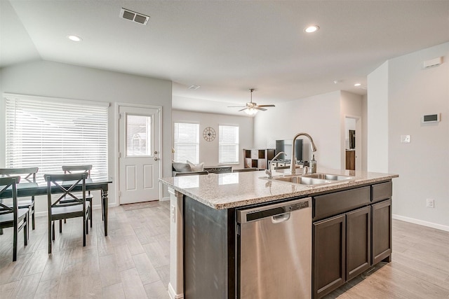 kitchen featuring dishwasher, light wood finished floors, a sink, and visible vents