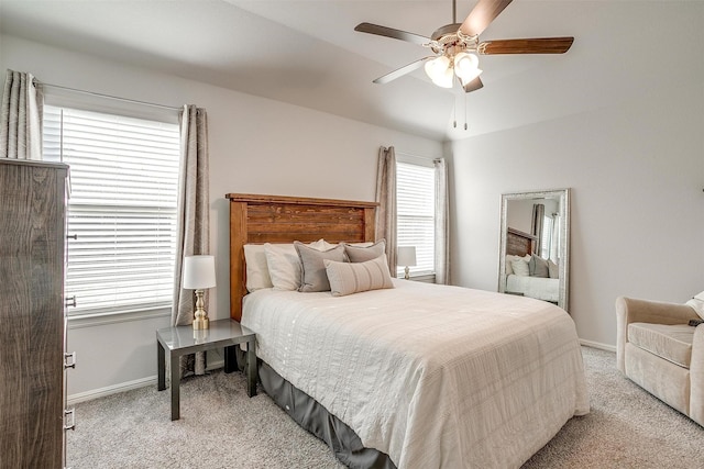 carpeted bedroom with ceiling fan and baseboards