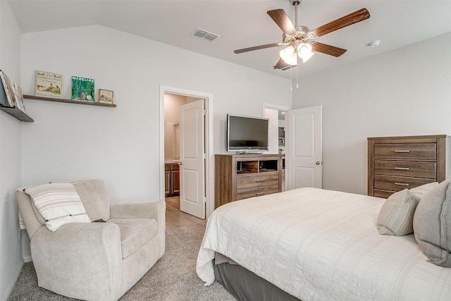 bedroom with lofted ceiling, visible vents, ceiling fan, and ensuite bathroom