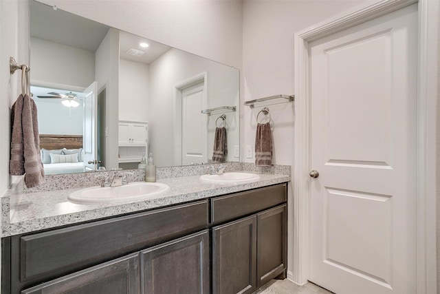 bathroom with double vanity, ensuite bath, a sink, and visible vents