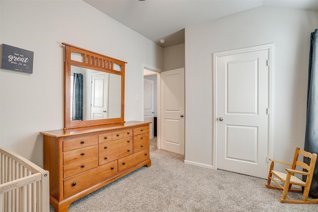 bedroom featuring vaulted ceiling and light colored carpet