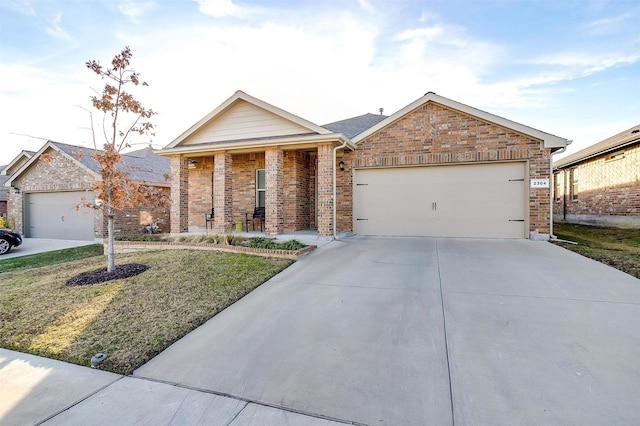 single story home with an attached garage, covered porch, brick siding, concrete driveway, and a front yard