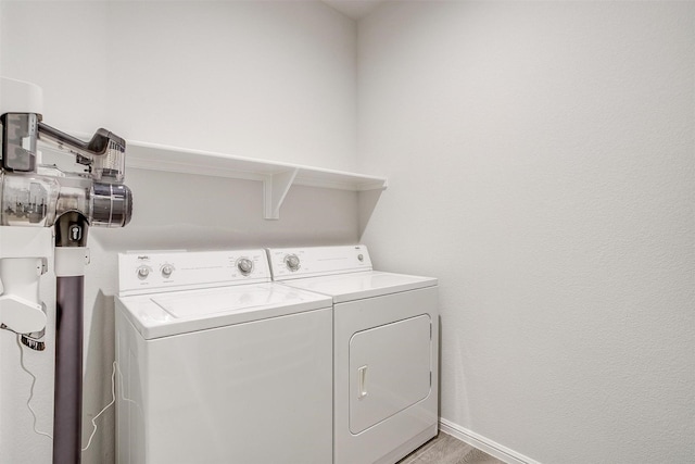 laundry room featuring laundry area, independent washer and dryer, and baseboards