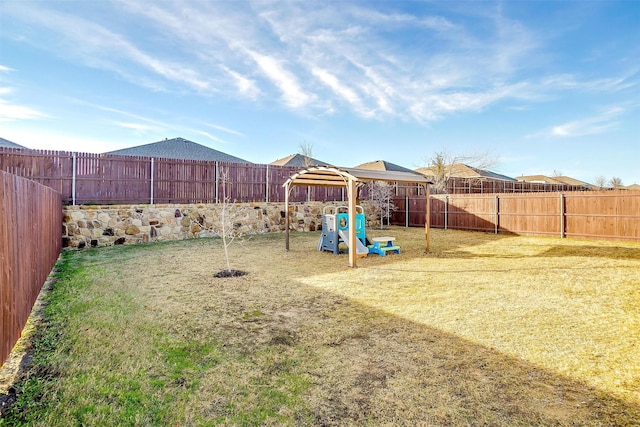 view of play area with a fenced backyard and a yard