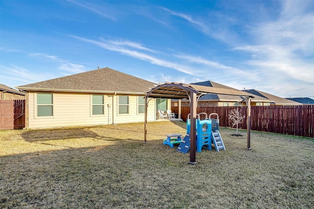 view of play area with a patio area, a fenced backyard, and a lawn