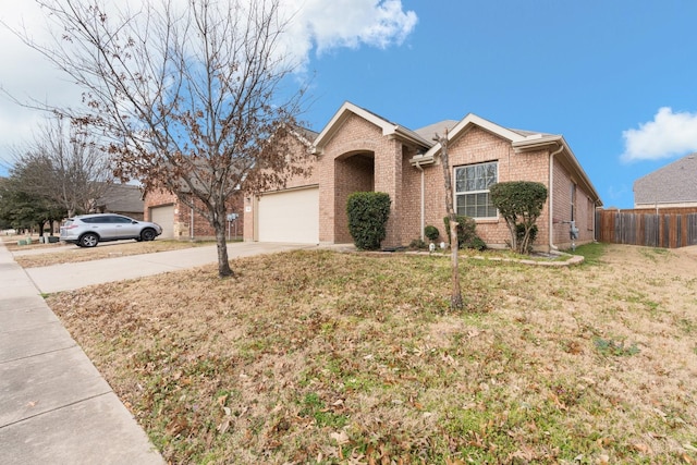 ranch-style house featuring an attached garage, brick siding, fence, driveway, and a front lawn