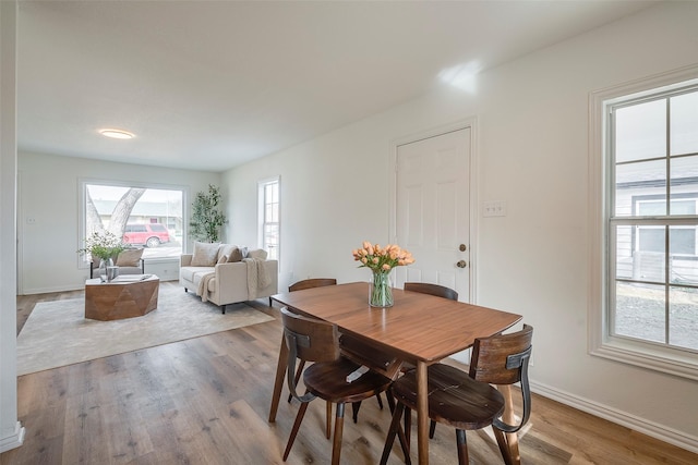 dining area featuring baseboards and wood finished floors