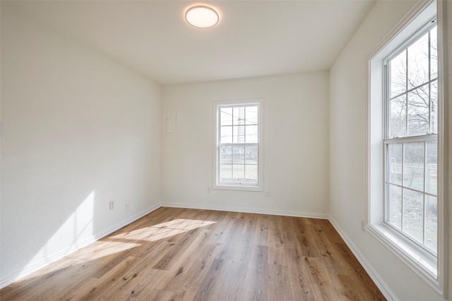 unfurnished room featuring light wood-style floors and baseboards