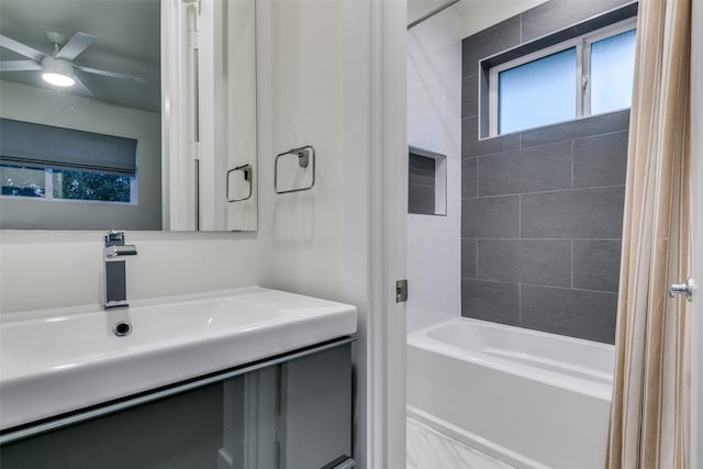 bathroom with shower / washtub combination, a ceiling fan, and vanity