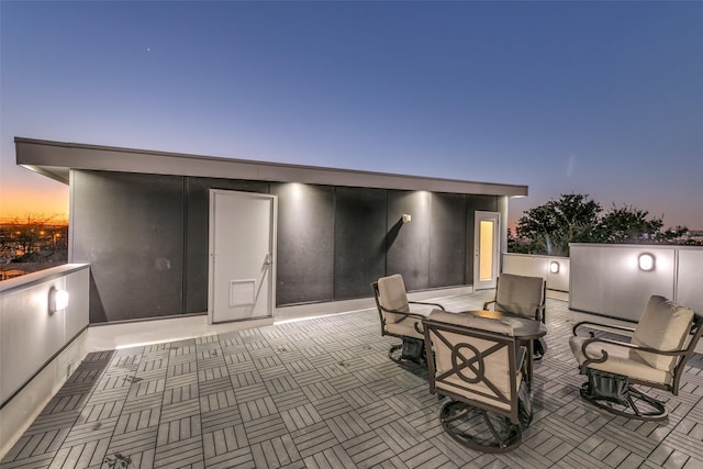 view of patio terrace at dusk