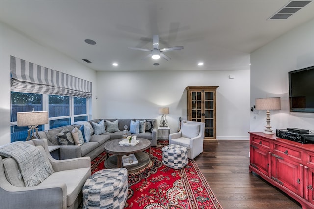 living room featuring baseboards, dark wood-type flooring, visible vents, and recessed lighting