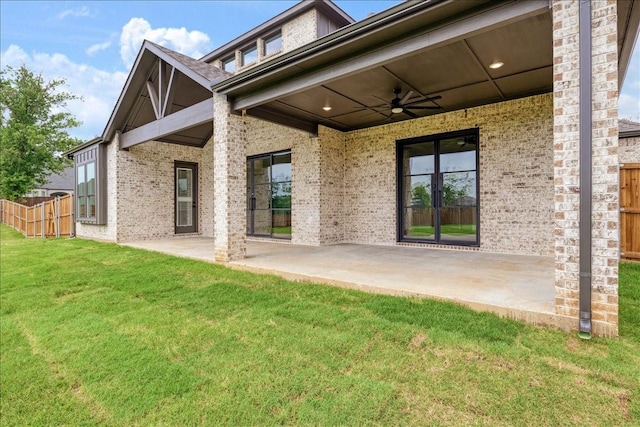 back of property with a patio area, ceiling fan, and fence