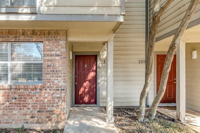 entrance to property with brick siding