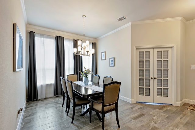2101 Bishop Barrel Ln, Wylie, TX 75098 - dining room with a chandelier, baseboards, light wood-style flooring, ornamental molding, and french doors