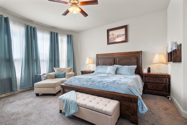 carpeted bedroom with a ceiling fan and baseboards