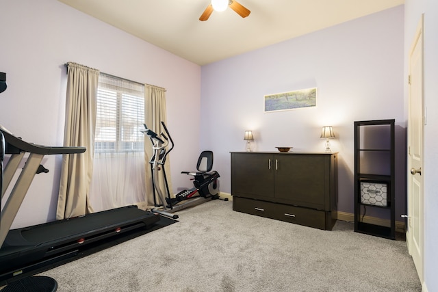 exercise area featuring carpet floors, baseboards, and a ceiling fan