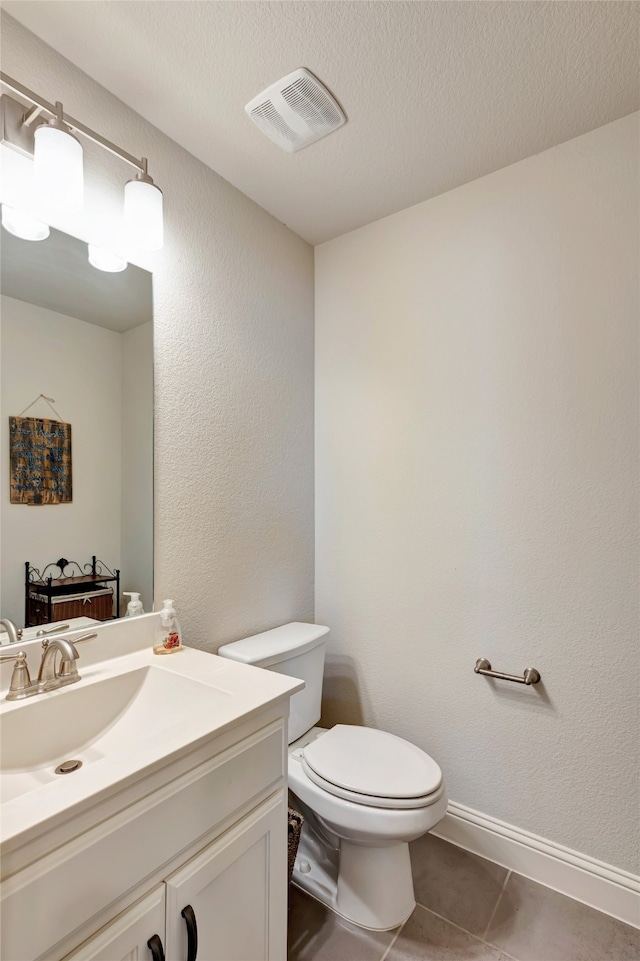 2101 Bishop Barrel Ln, Wylie, TX 75098 - half bathroom with vanity, toilet, tile patterned flooring, and a textured ceiling