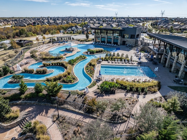 community pool with a residential view and a patio